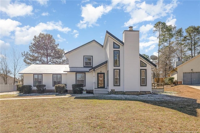 mid-century modern home featuring a front lawn, a chimney, and fence