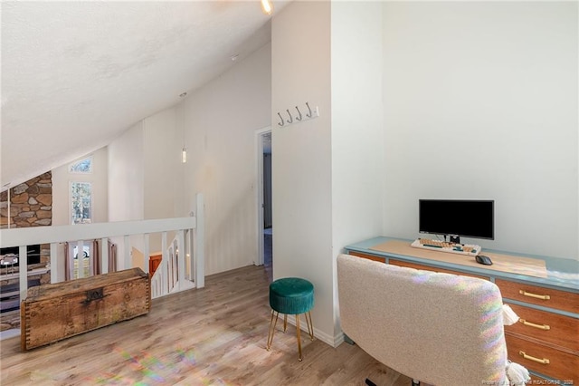 office area with high vaulted ceiling and wood finished floors