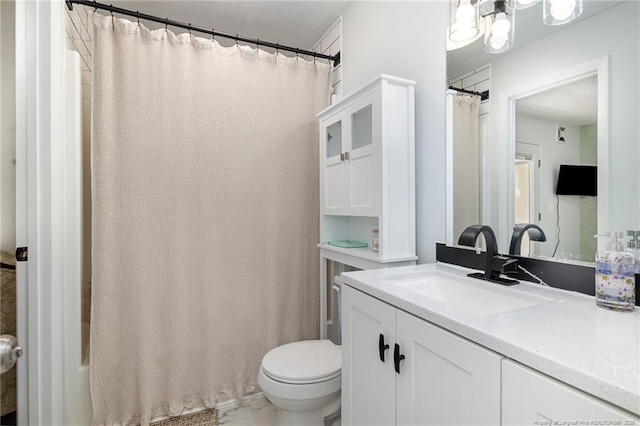 bathroom with curtained shower, marble finish floor, vanity, and toilet