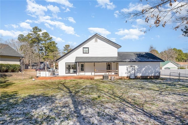 rear view of house with fence private yard, central AC unit, a deck, and a yard