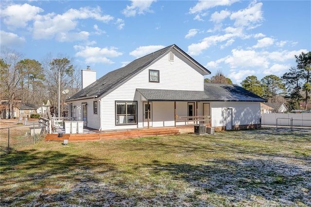 back of property with a fenced backyard, central air condition unit, a lawn, a wooden deck, and a chimney