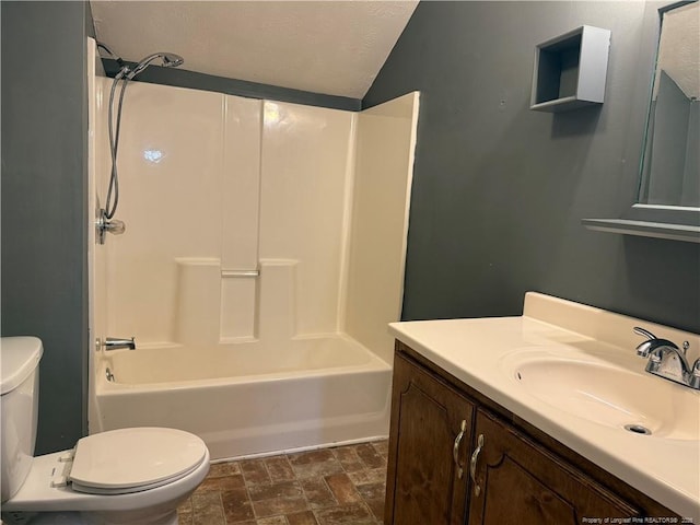 full bath with shower / bathing tub combination, stone finish floor, vanity, and toilet