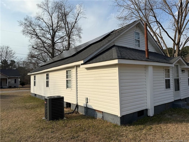 view of property exterior with a shingled roof, crawl space, cooling unit, and a lawn