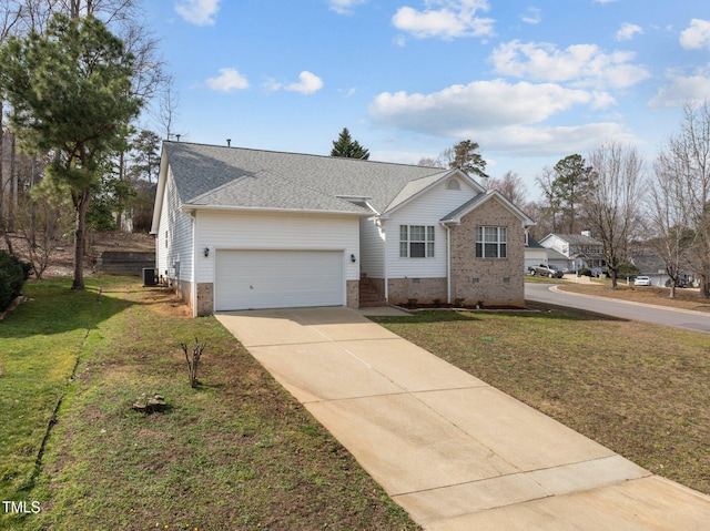 view of front of property with a shingled roof, concrete driveway, an attached garage, crawl space, and a front lawn