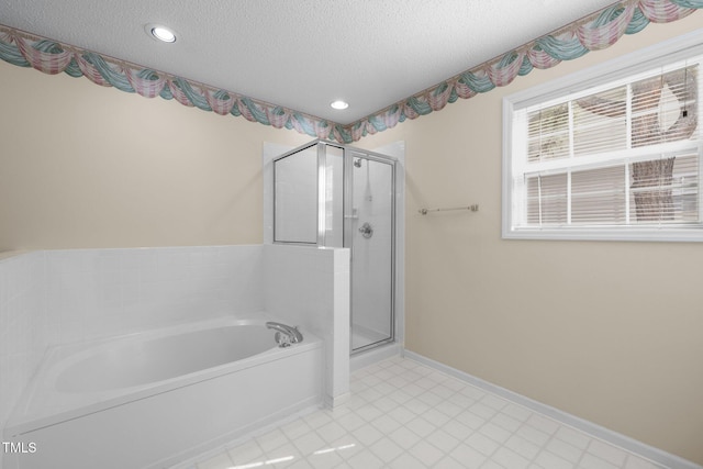 bathroom with a stall shower, baseboards, a garden tub, a textured ceiling, and recessed lighting