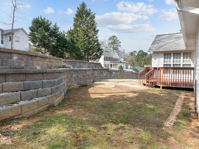 view of yard featuring a deck and fence