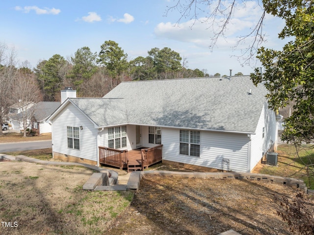 rear view of house with a shingled roof, crawl space, and a chimney