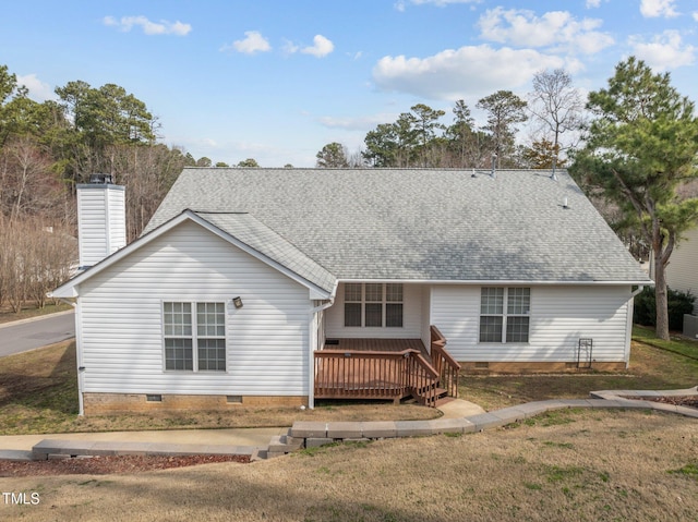 view of front of home featuring a deck, roof with shingles, crawl space, a chimney, and a front yard