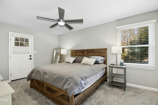 carpeted bedroom with a ceiling fan and baseboards