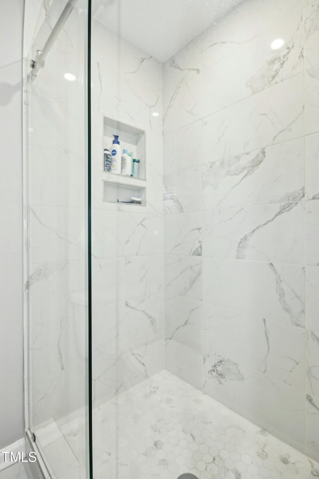 full bath featuring a marble finish shower