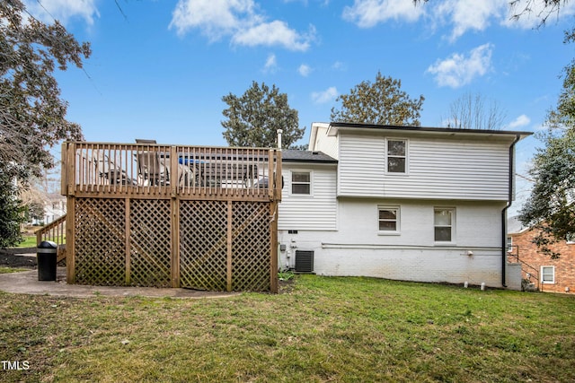 back of property featuring a deck, central air condition unit, brick siding, crawl space, and a lawn