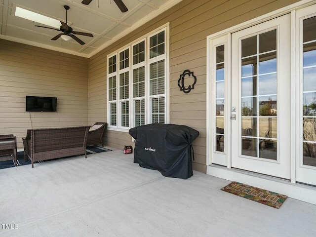 view of patio with area for grilling and a ceiling fan