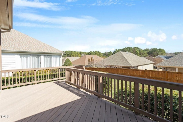 deck with a residential view and fence