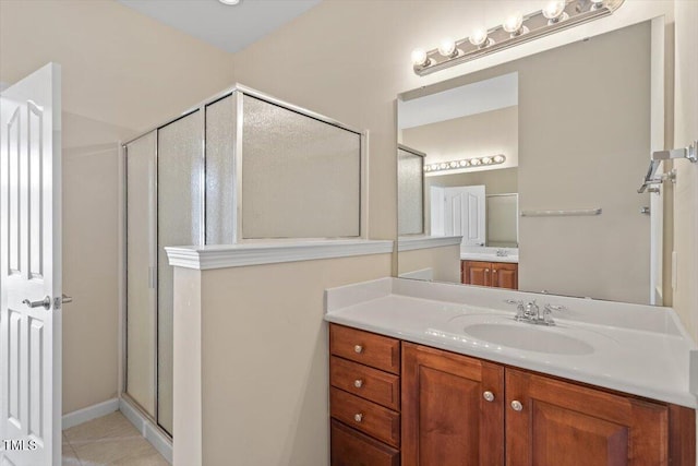 bathroom with a shower stall and vanity