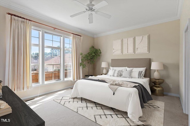 bedroom with a ceiling fan, baseboards, ornamental molding, and carpet flooring