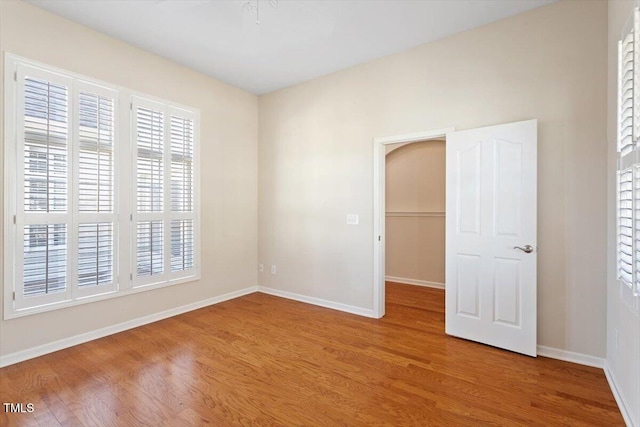 empty room with light wood-style flooring and baseboards