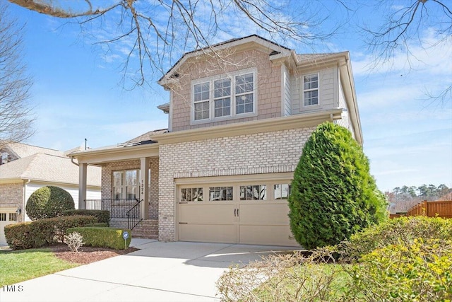 view of front of home with concrete driveway, brick siding, and an attached garage