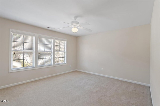 unfurnished room featuring ceiling fan, baseboards, and light colored carpet