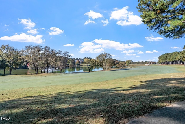 view of property's community featuring a lawn and a water view