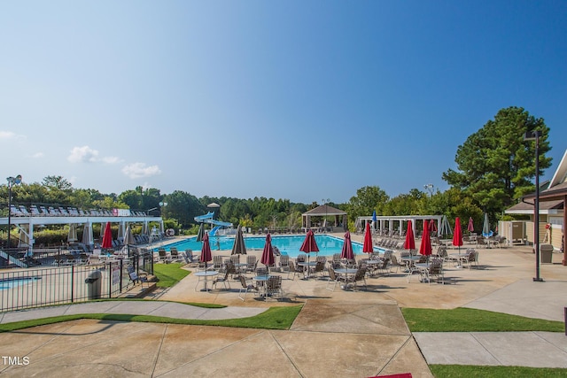 pool featuring a patio area and fence