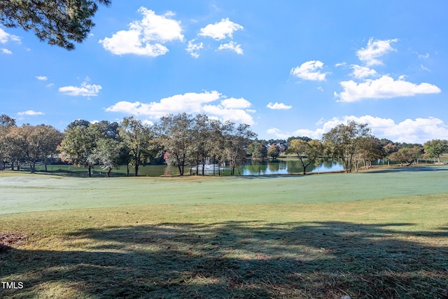 view of home's community featuring a water view and a lawn