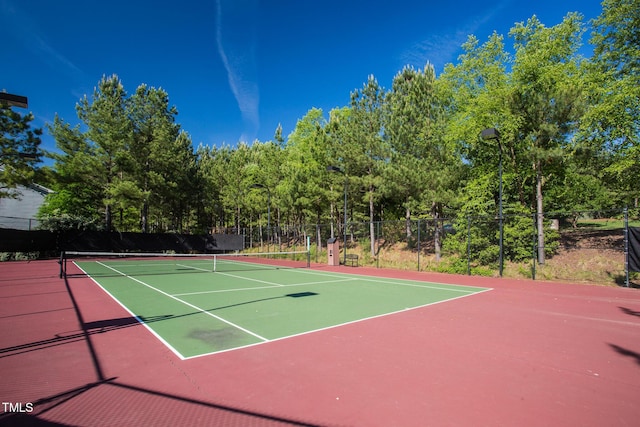 view of tennis court featuring fence