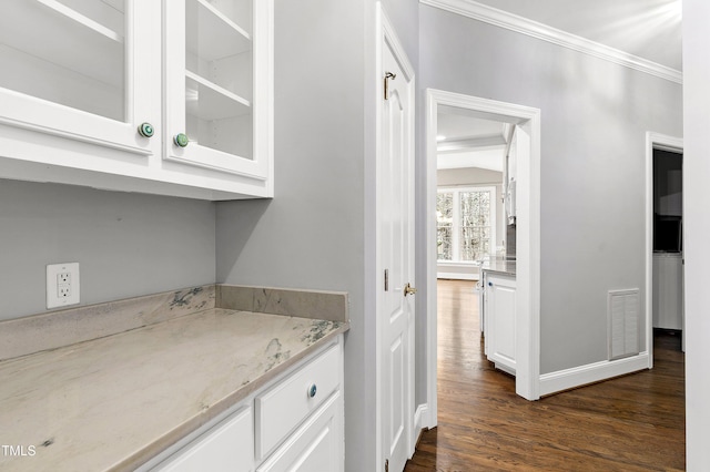 interior space with visible vents, crown molding, and dark wood-type flooring