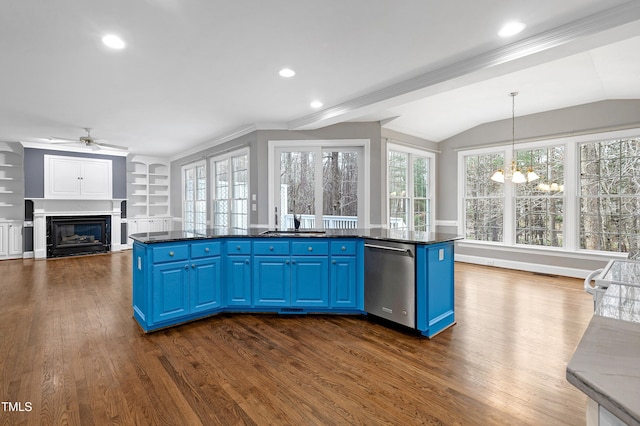 kitchen featuring blue cabinetry, dishwasher, a glass covered fireplace, and dark wood-style flooring