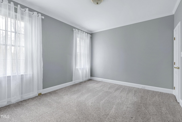 spare room with carpet flooring, baseboards, and ornamental molding