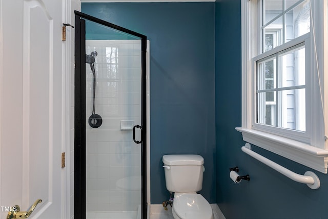 full bathroom featuring a shower stall and toilet