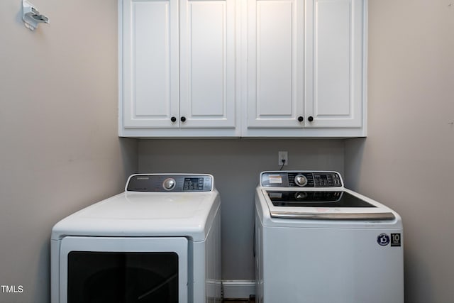 laundry area with cabinet space and independent washer and dryer