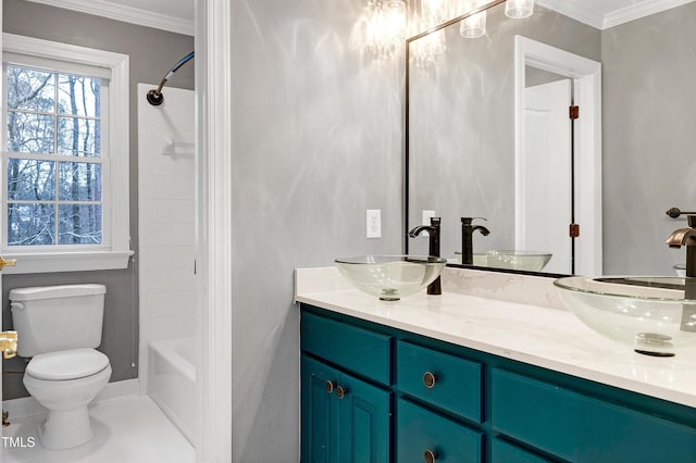 bathroom featuring a sink, toilet, double vanity, and crown molding