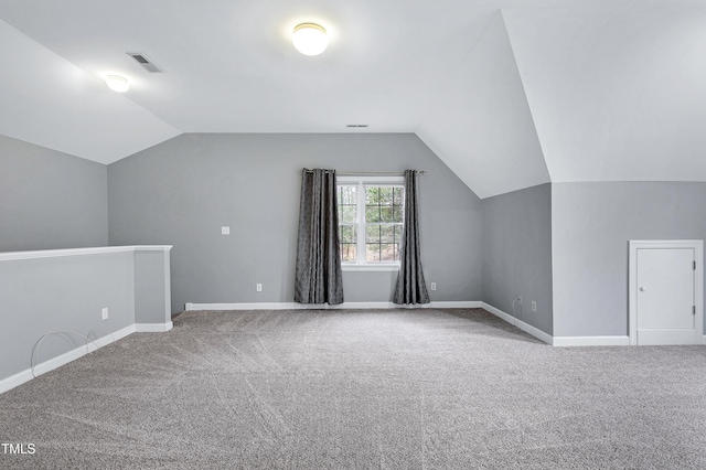 bonus room with lofted ceiling, carpet, visible vents, and baseboards