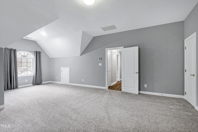 bonus room with baseboards, carpet floors, visible vents, and vaulted ceiling