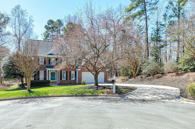 view of front of home with a front yard, brick siding, an attached garage, and driveway