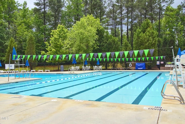 pool featuring a patio and fence