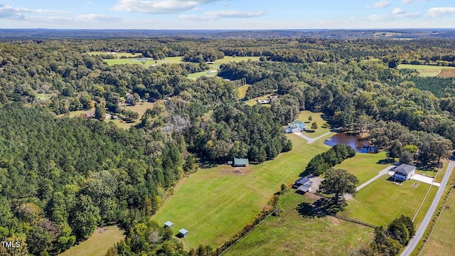 bird's eye view with a wooded view