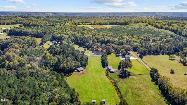drone / aerial view with a water view and a view of trees