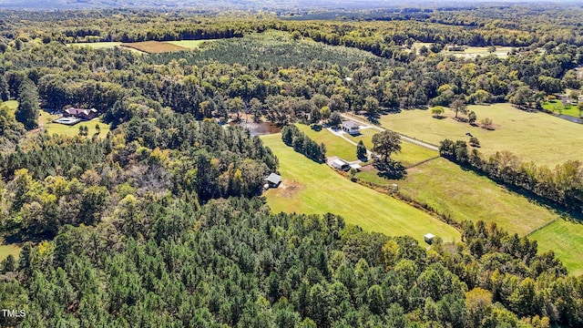 birds eye view of property with a view of trees