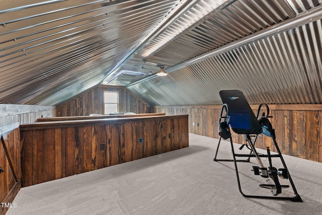 unfurnished office with carpet floors, lofted ceiling, and wooden walls