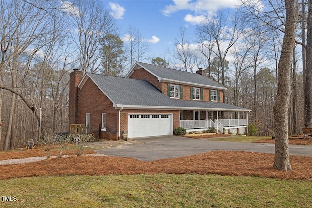 view of front of home featuring covered porch, a garage, brick siding, driveway, and a chimney