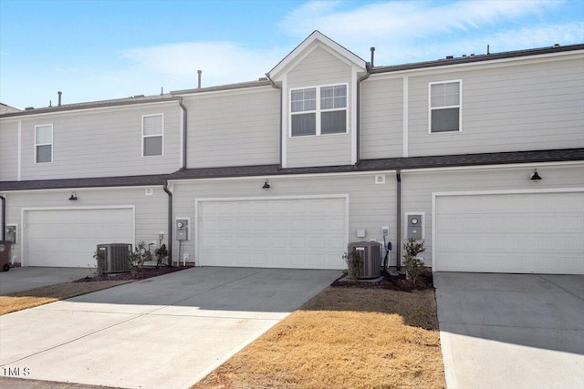 view of front facade with a garage, driveway, and central AC unit