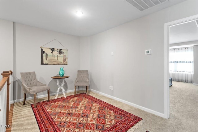 living area featuring carpet flooring, visible vents, and baseboards