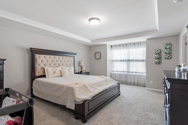 bedroom with light carpet, baseboards, and a raised ceiling