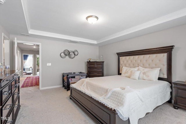 bedroom featuring light carpet, baseboards, visible vents, ornamental molding, and a tray ceiling