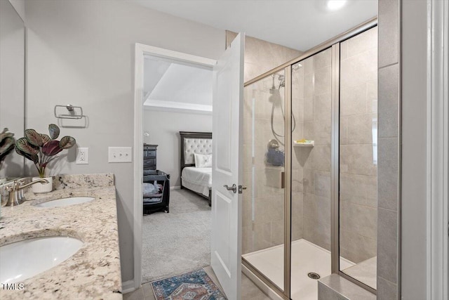 ensuite bathroom featuring double vanity, ensuite bath, a shower stall, and a sink