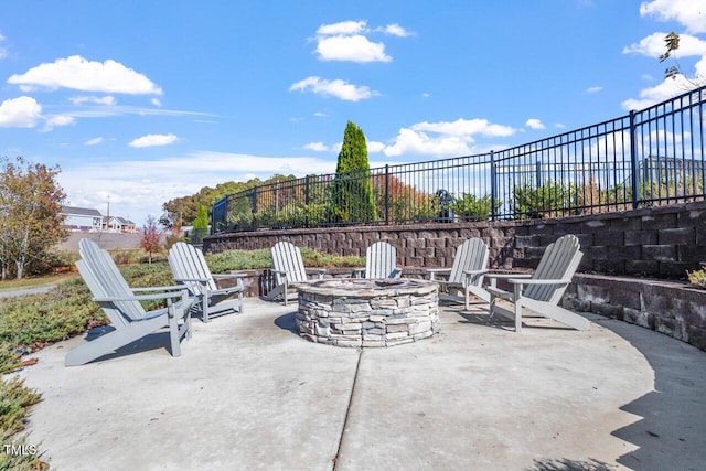 view of patio / terrace with an outdoor fire pit and fence