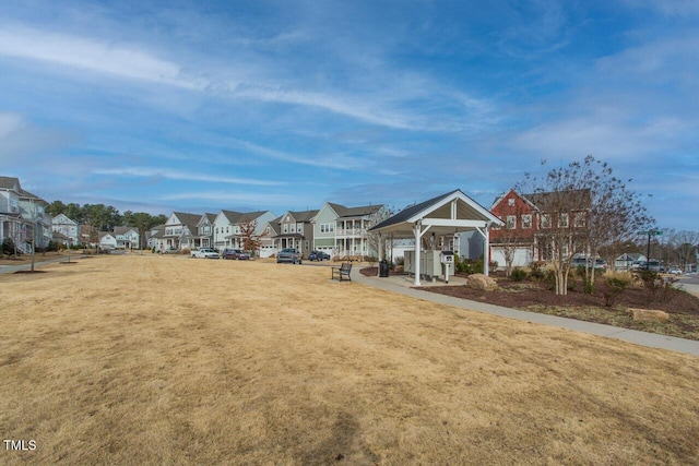 view of property's community with a residential view, a lawn, and a gazebo