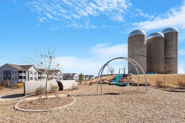 community jungle gym with a residential view