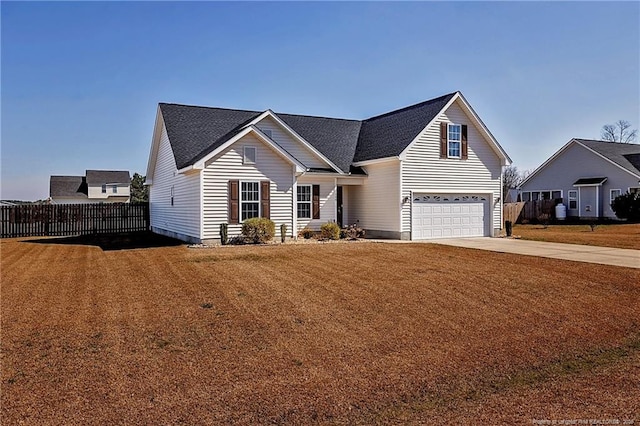 traditional-style home featuring a garage, concrete driveway, fence, and a front lawn